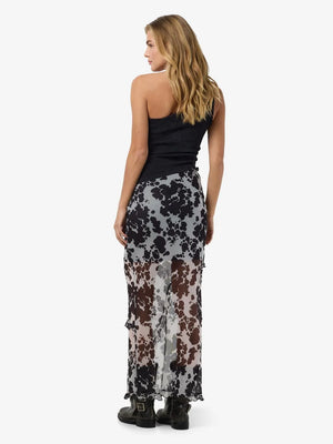 Rosa Long Cutline Slit Skirt in Black cow print featuring short underlining skirt with slide slit.